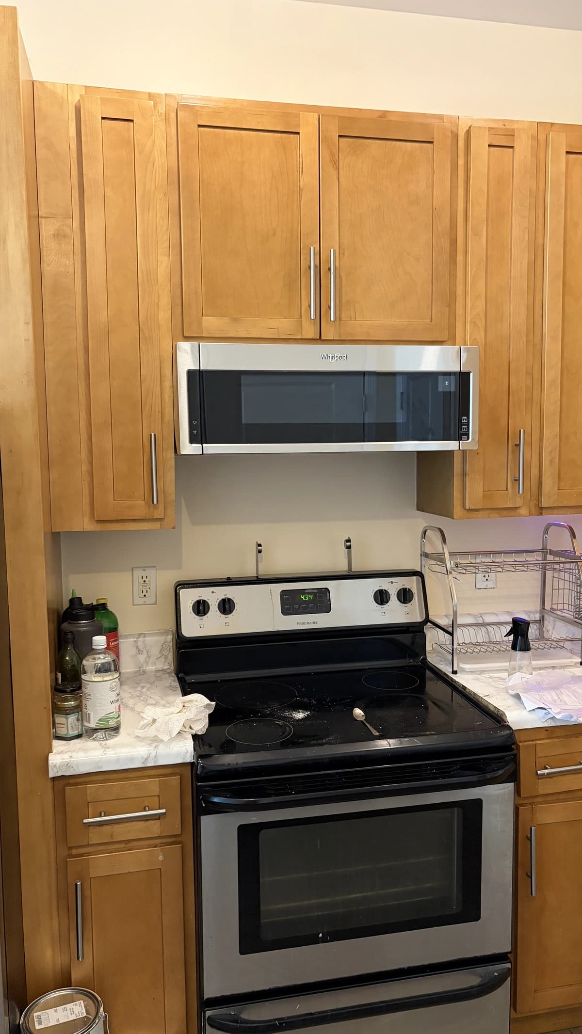 Over-the-range microwave installed beneath kitchen cabinets above a stove