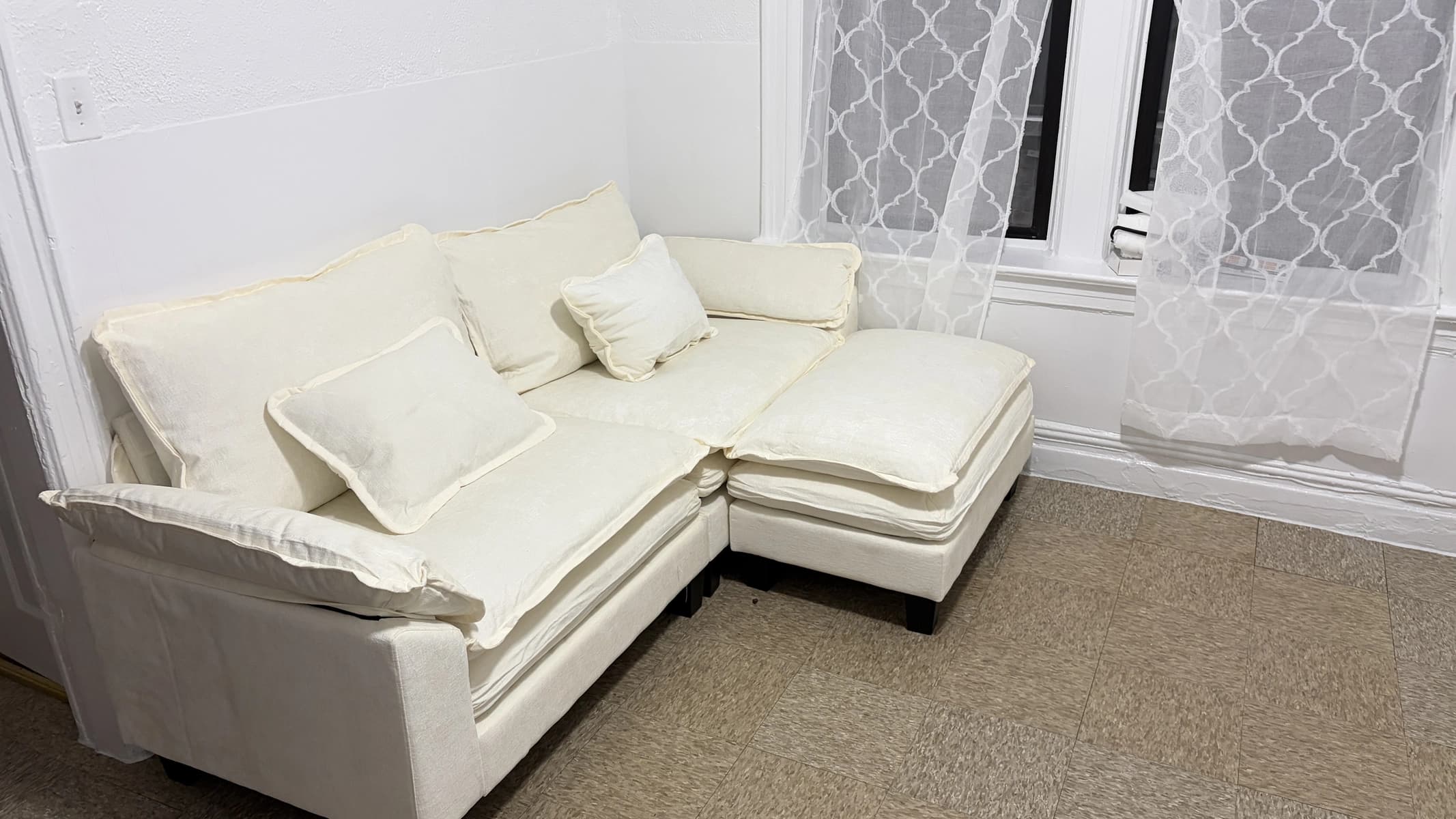 Newly assembled white sectional sofa in a living room